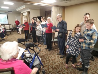 Group of congregants singing carols at retirement home