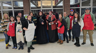 Group of people posing for photo after Sunday Supper served
