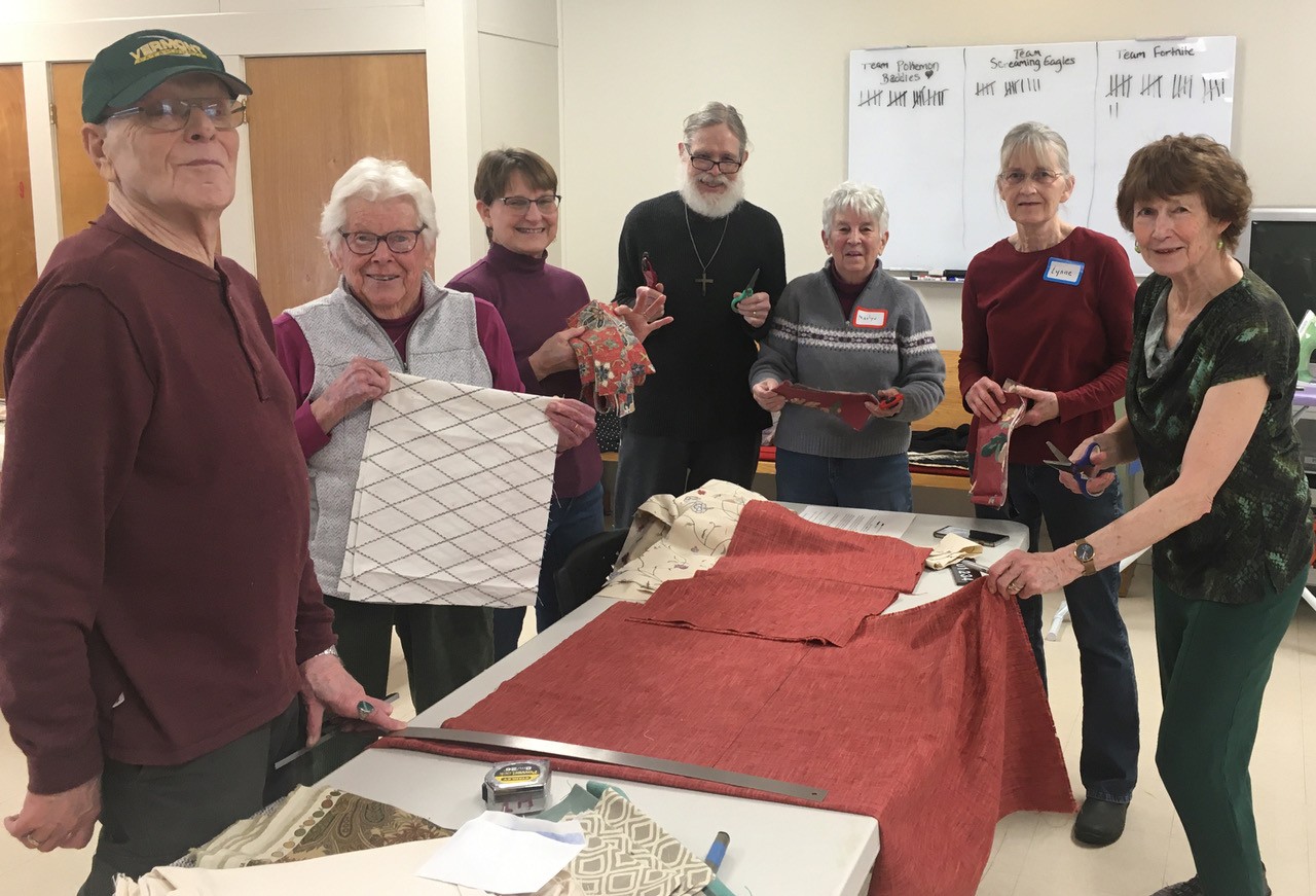 Group of people working on assembling school kits