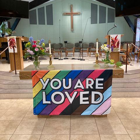 church alter with you are loved banner,