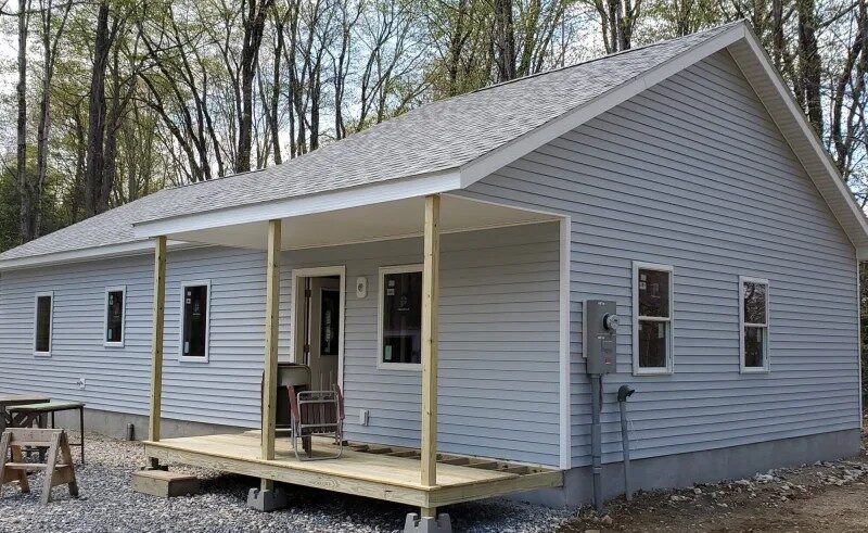 new single floor blue home with unfinished porch