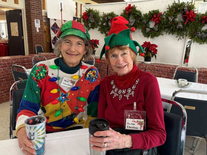 Two smiling women in holiday outfits