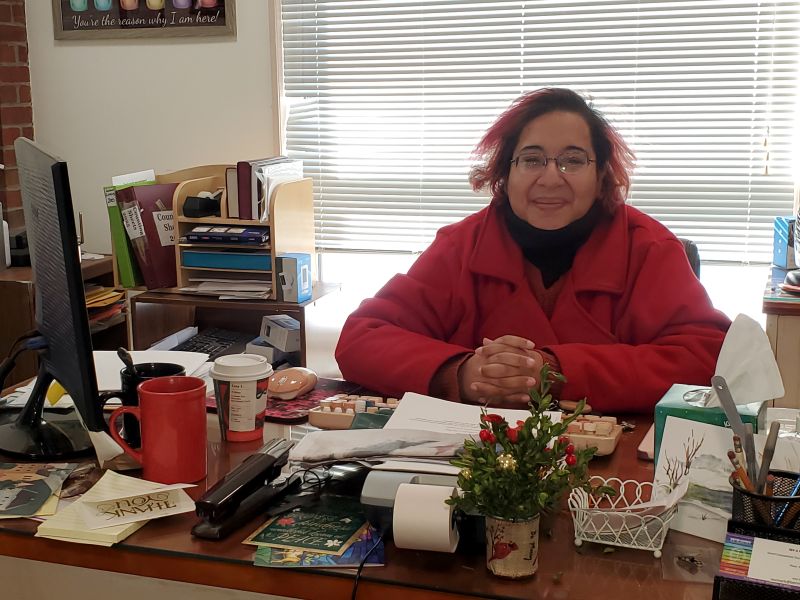 Smiling woman sitting at a desk