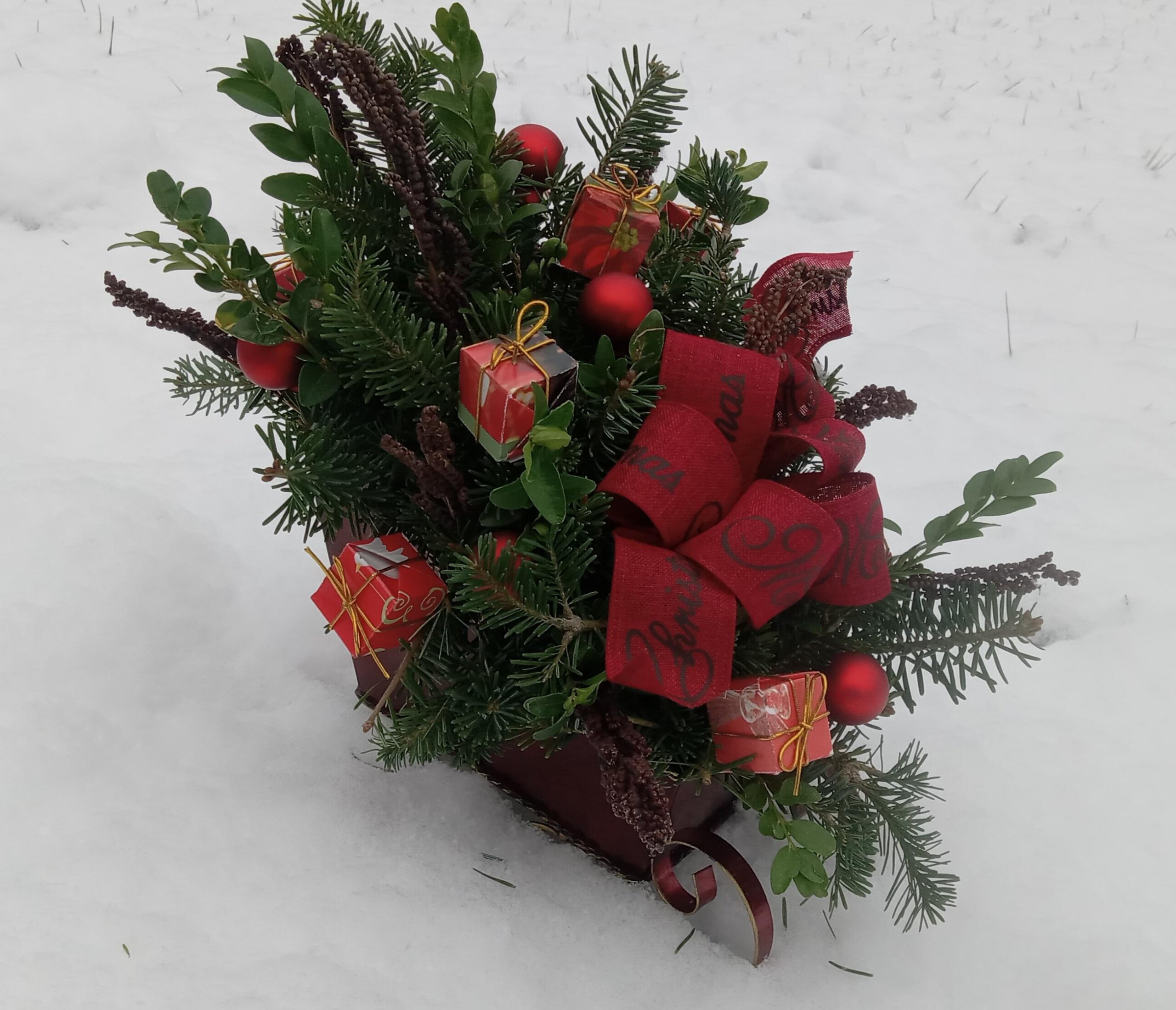 Beautiful sleigh filled with greens and decorations